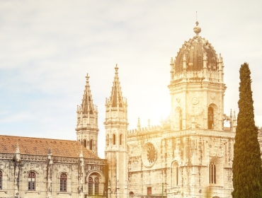 Visit the Mosteiro dos Jerónimos and munch a pastel de nata